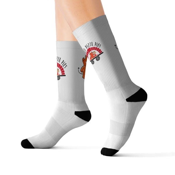 White crew socks with black toes and heels, featuring a pizza pies logo and a cartoon devil.